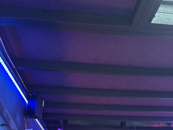Blue LED strip lighting installed along ceiling beams